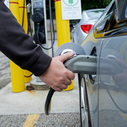 man charging his electric vehicle